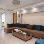Brown sofa blue cushions, chandelier , living room interior design - LuXia LLP